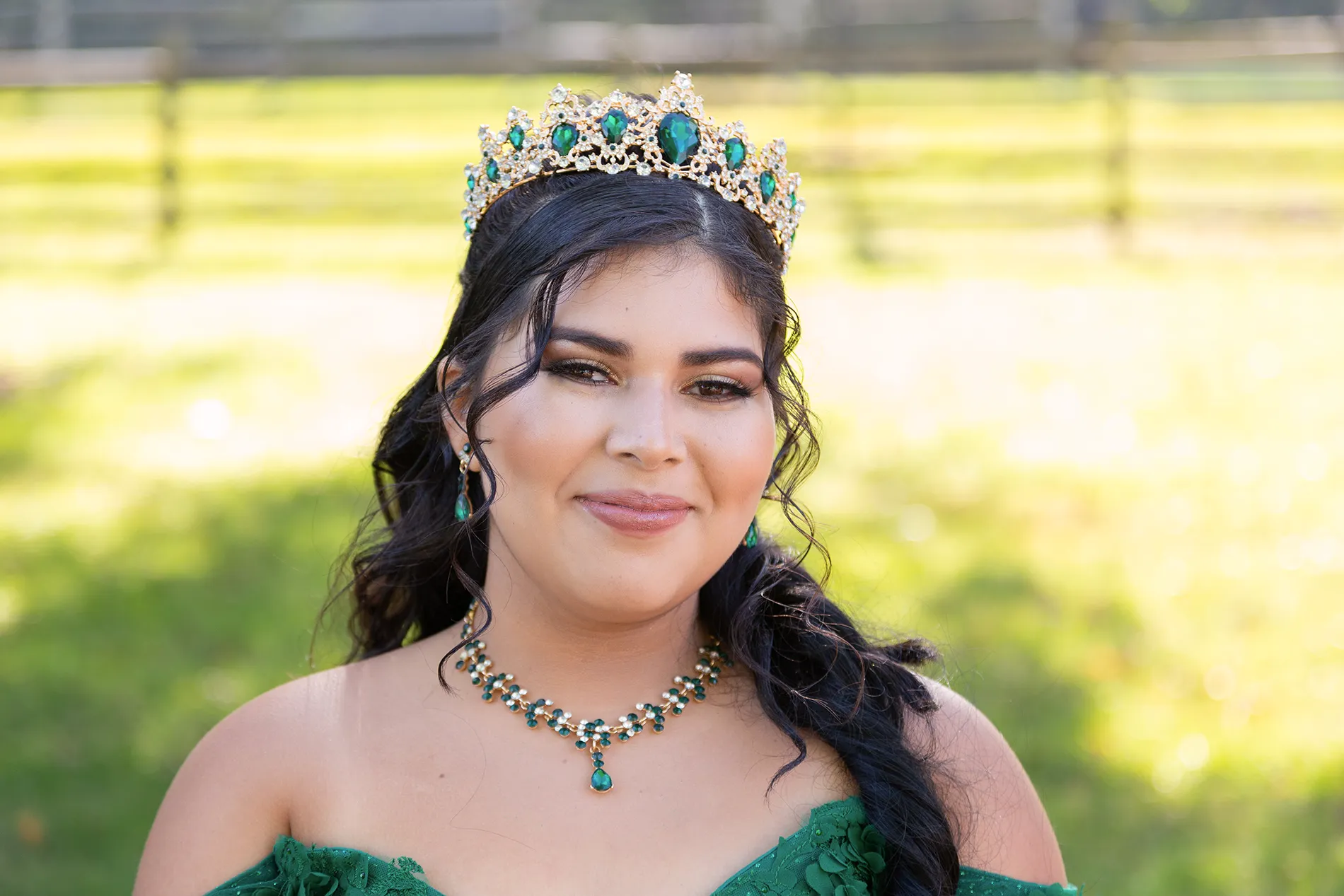 Close-up portrait of a quinceañera wearing an emerald crown and dress at Bethel Woods Center for the Arts, NY — quince photo session / sesión de fotos de quinceañera.